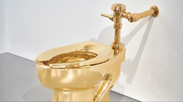 <ruby ><rb><span class="unknown" word="風刺">風刺</span></rb><rt>ふうし</rt></ruby><ruby ><rb><span class="jlpt-n3" word="芸術">芸術</span></rb><rt>げいじゅつ</rt></ruby><span class="" word="の">の</span><ruby ><rb><span class="jlpt-n1" word="象徴">象徴</span></rb><rt>しょうちょう</rt></ruby><span class="" word="「">「</span><ruby ><rb><span class="jlpt-n3" word="金">金</span></rb><rt>きん</rt></ruby><span class="" word="の">の</span><span class="jlpt-n5" word="トイレ">トイレ</span><span class="" word="」">」</span><ruby ><rb><span class="jlpt-n1" word="第">第</span><span class="" word="2">2</span><span class="jlpt-n1" word="作">作</span></rb><rt>だいにさく</rt></ruby><span class="" word="、">、</span><span class="" word="サ">サ</span><span class="" word="ザ">ザ</span><span class="" word="ビ">ビ</span><span class="" word="ー">ー</span><span class="" word="ズ">ズ</span><span class="" word="で">で</span><ruby ><rb><span class="unknown" word="競売">競売</span></rb><rt>きょうばい</rt></ruby><span class="" word="へ">へ</span><span class="" word="―">―</span><span class="" word="―">―</span><ruby ><rb><span class="" word="芸">芸</span><span class="" word="術">術</span><span class="jlpt-n3" word="性">性</span></rb><rt>げいじゅつせい</rt></ruby><span class="" word="と">と</span><ruby ><rb><span class="jlpt-n3" word="物質">物質</span><span class="jlpt-n1" word="的">的</span></rb><rt>ぶっしつてき</rt></ruby><ruby ><rb><span class="jlpt-n3" word="価値">価値</span></rb><rt>かち</rt></ruby><span class="" word="を">を</span><span class="" word="め">め</span><span class="" word="ぐ">ぐ</span><span class="" word="っ">っ</span><span class="" word="て">て</span>